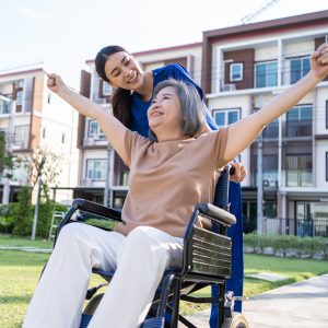 Happy Women in Wheelchair with Nurse