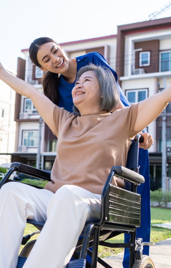 Happy Women in Wheelchair with Nurse