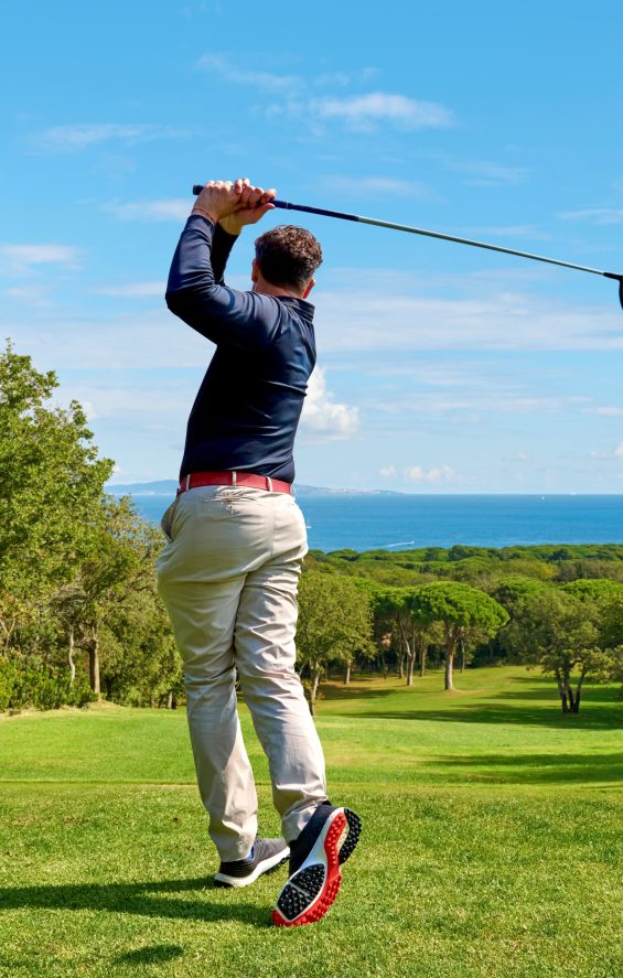 Golfer on Golf Course Hitting Ball